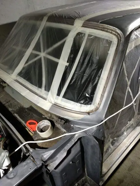 View of the opening of the windshield and the opening of the front door with stretched film