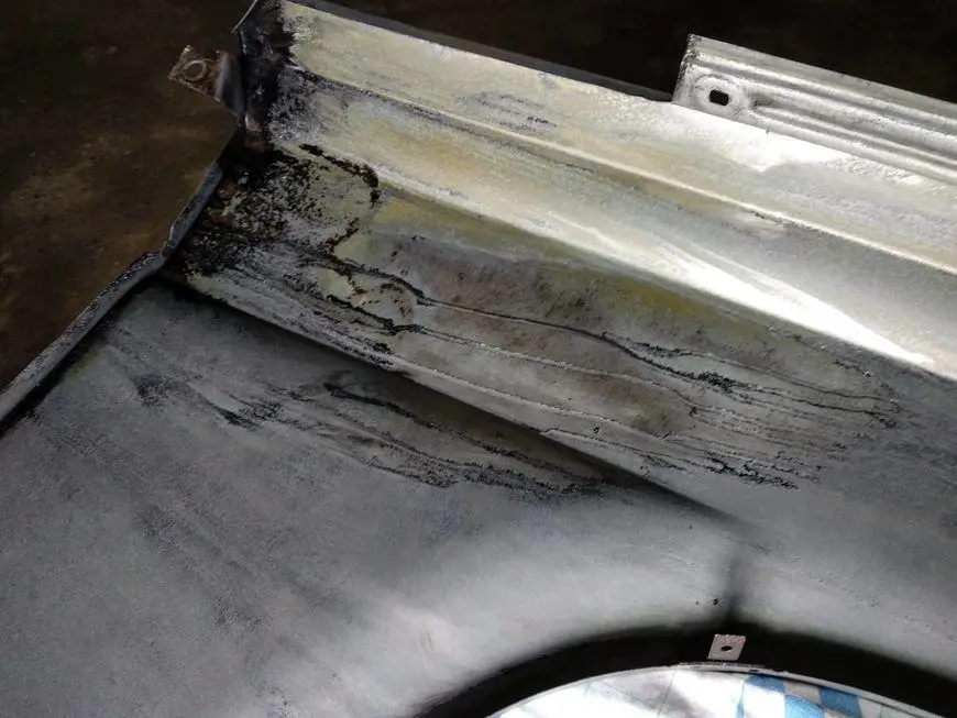 The inner rear of the wing after cleaning and treatment with a rust converter