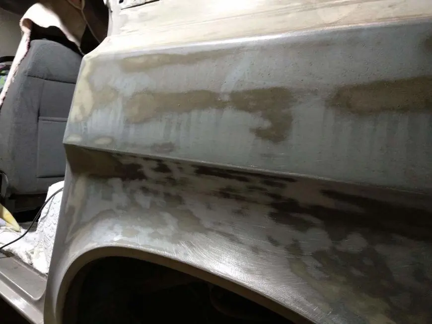 Rear fender treated with sandpaper and rust converter - rear view